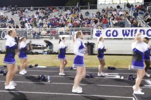 Cheerleaders performing at football game