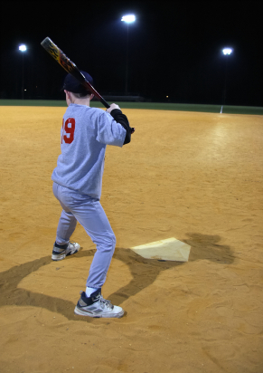 Young baseball player batting in a showcase event.