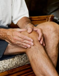 man massaging knee pain_2
