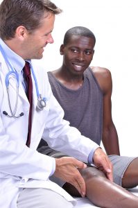 Doctor performing pre-participation physical exam