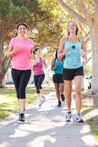 Women jogging on sidewalk