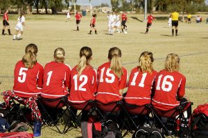 Female soccer team on bench
