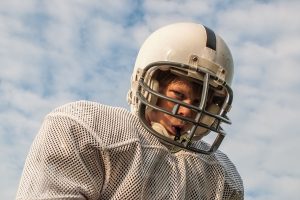 Boy football player with helmet and mouthguard