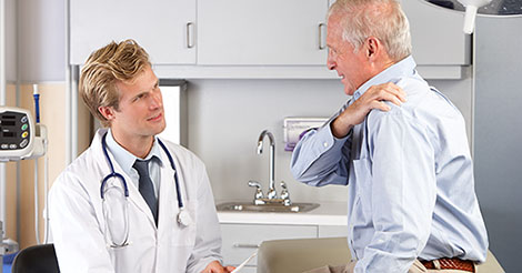 Doctor talking to a patient about his shoulder pain