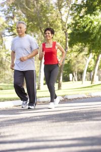 Older couple jogging in park