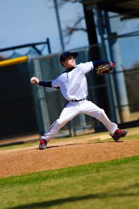 Youth baseball pitcher in white