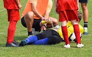 Athletic trainer treating sports injuries