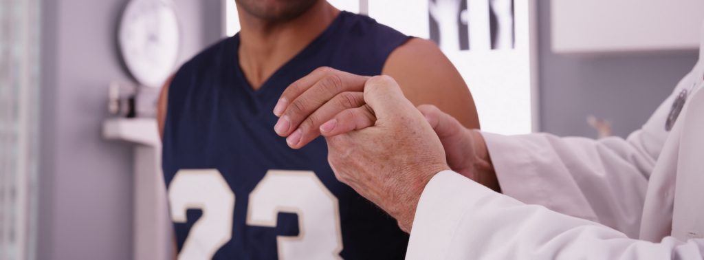 NFL team doctor examines a player