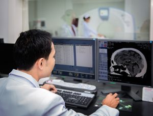 Doctor looking for evidence of brain damage in football player