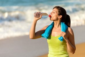Woman drinks coconut water after exercise