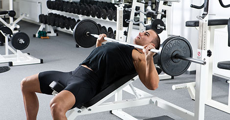 Man performing bench press lifting weights