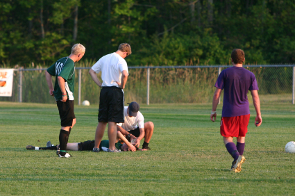 Injured soccer player lying on the field