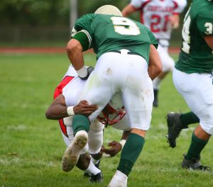 Football players must keep their heads up when tackling to avoid cervical spine injuries 