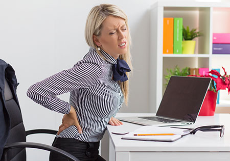 Woman with pain at work after an injury